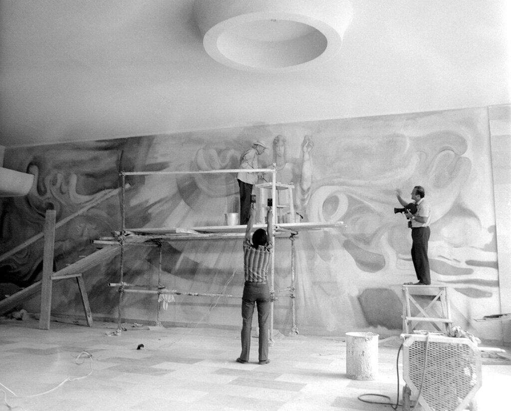 Казанлъшкият художник Дечко Узунов,довършва паното "Розоберачка", във фоаето на хотел Казанлък.
Зад кинокамерата ф.х. Артин Азинян,който снима филм за бай Дечко Узунов.
1981 година